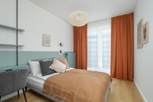 a bedroom with a bed and a window with orange curtains at Unique 2-Bedroom Apartment on the 10th Floor with FREE GARAGE Poznań by Renters in Poznań