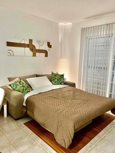 a bedroom with a large bed and a large window at Piera's Apartment in Chayofa