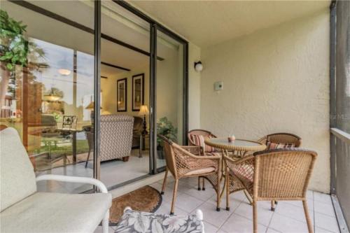 a patio with a table and chairs on a balcony at MyCataleya Comfy Condo near Beach (Bradenton) in Bradenton
