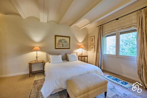 a bedroom with a large bed and a window at Casa Torre de les Àligues in Bellver de Cerdanya 