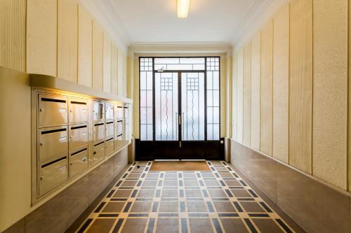 a hallway with a door to a room with a window at Artois Champs-Elysées in Paris
