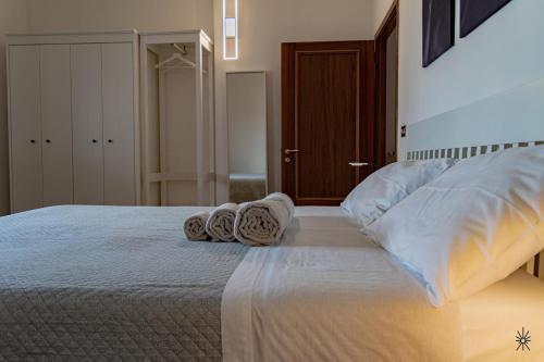 a bedroom with a bed with towels on it at Rooftop Madreperla in Taranto