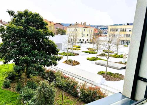 a view of a courtyard with trees and buildings at Apartments & rooms Artemus Belveder in Koper