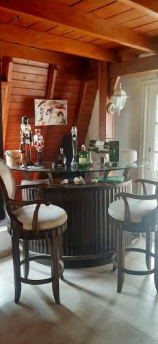 a kitchen with a counter with chairs and a table at LE CHALET in Barranquilla