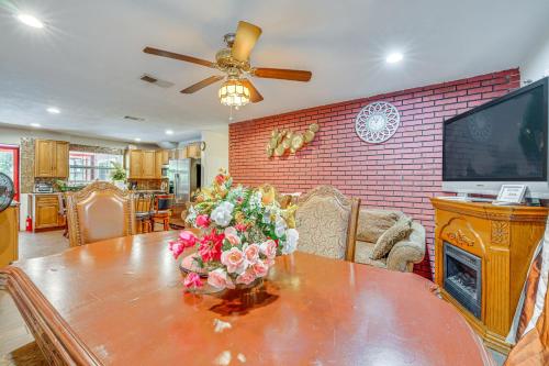 a living room with a table with a vase of flowers on it at Oasis with Grill and Pool about 16 Mi to Orlando! in Orlando