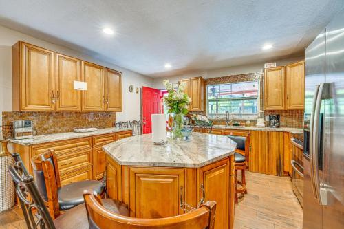 a kitchen with wooden cabinets and a island in it at Oasis with Grill and Pool about 16 Mi to Orlando! in Orlando