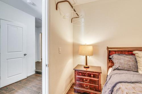 a bedroom with a bed and a lamp on a night stand at Oasis with Grill and Pool about 16 Mi to Orlando! in Orlando