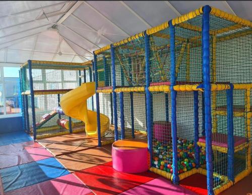 a play room with a slide and a playground at Laurel 20 holidayhome in Rhyl