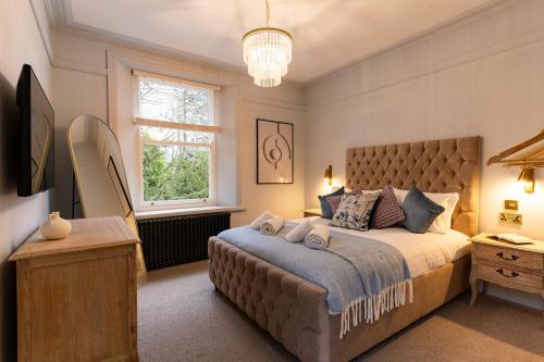 a bedroom with a large bed and a window at Calming Crescent in Buxton