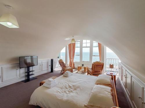 a bedroom with a large bed with a view of the ocean at Seascape in Ramsgate