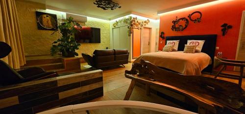 a room with a bedroom with a bed and a chair at Mei Hôtel-Restaurant in Sarrebourg