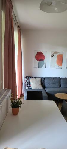 a living room with a couch and a table at Lovely One-Bedroom Condo With Patio. in Warsaw