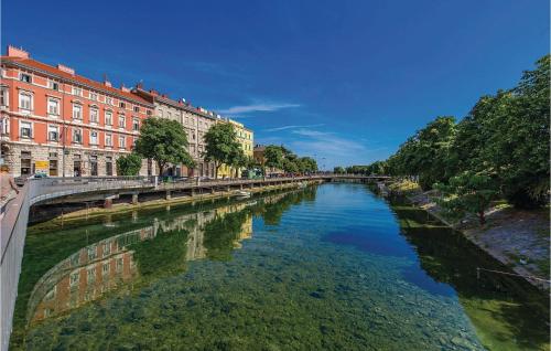 a river in a city with buildings next to it at Lovely Home In Rijeka With Wifi in Rijeka