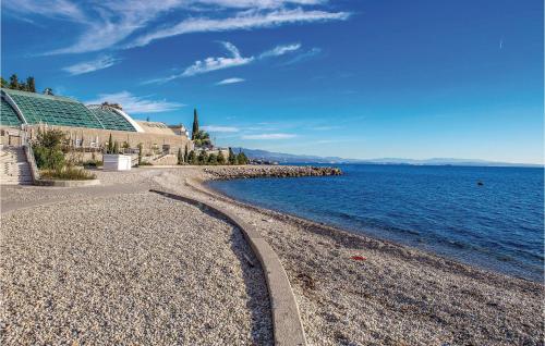 a rocky beach next to a large body of water at Lovely Home In Rijeka With Wifi in Rijeka