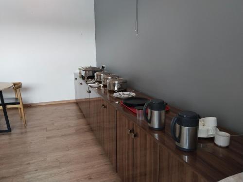 a counter with pots and pans on top of it at TREETOP INN in Chennai