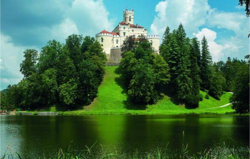 a castle on top of a hill next to a lake at Lovely Home In Vinogradi Ludbreski in Ludbreg