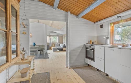a kitchen with white walls and a wooden ceiling at 3 Bedroom Gorgeous Home In Rørvig in Rørvig