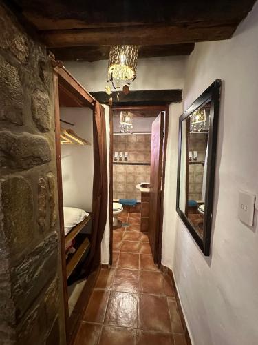 a hallway of a room with a bedroom and a mirror at Antigua Tilcara in Tilcara