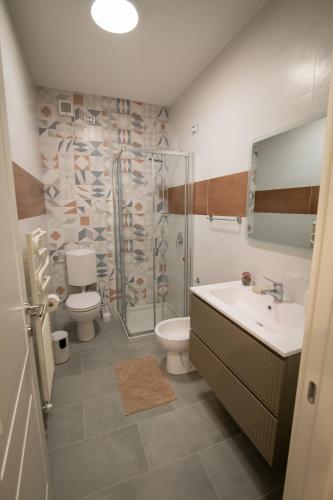 a bathroom with a shower and a sink and a toilet at Residenza Lago Sereno in Porto Ceresio