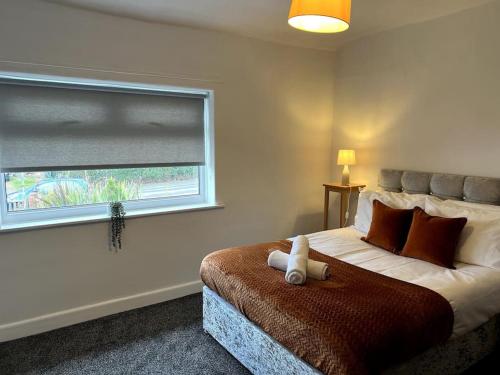 a bedroom with a bed with a teddy bear on it at Cleveland View in Stockton-on-Tees