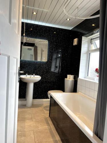 a bathroom with a sink and a bath tub and a sink at Cleveland View in Stockton-on-Tees