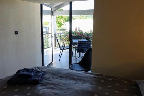 a bedroom with a bed and a view of a patio at Villa Pepa in Pazin