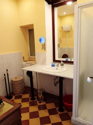 a bathroom with a sink and a mirror at Casa Angioletta in Taormina