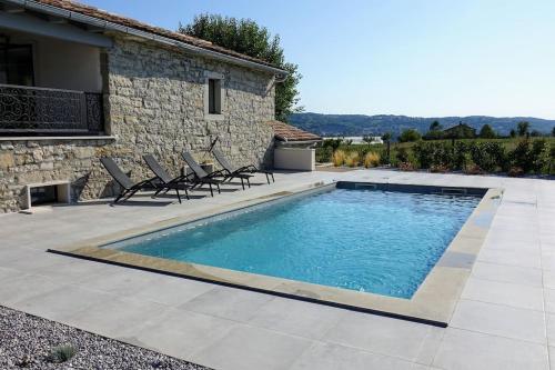 a swimming pool with chairs next to a house at Villa Pepa in Pazin