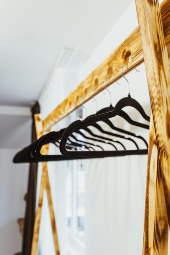 a wooden shelf with a black and white object at Casa Rosu in Cluj-Napoca