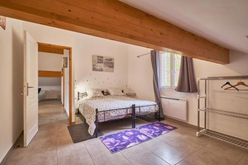 a bedroom with a bed and a large window at le bien-être de la nature in Séchilienne