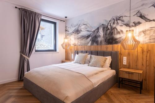 a bedroom with a bed with a painting on the wall at CASA IL TRAMONTO Val di Sole in Commezzadura