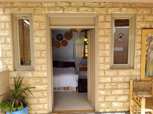 a doorway to a bedroom with a bed in a room at Surf & Salsa GuestHouse in Agadir