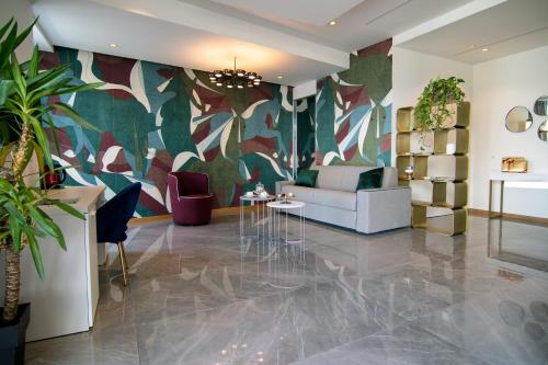 a living room with a couch and a colorful wall at Gigi Suites&Apartments in Stresa