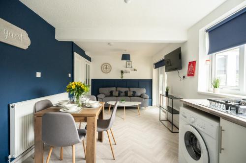 a kitchen and living room with a table and chairs at Renvyle House By Horizon Stays in Stockton-on-Tees