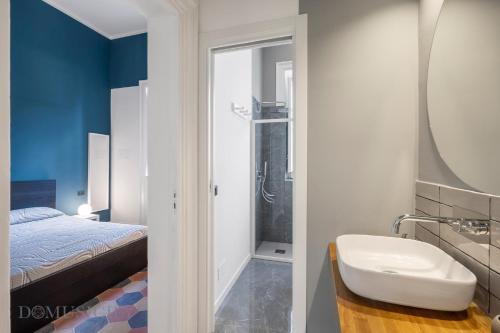 a bathroom with a bed and a sink and a mirror at Real Tenuta Apartments By Domus Sicily in Palermo