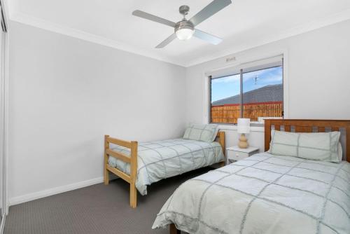 Ένα ή περισσότερα κρεβάτια σε δωμάτιο στο Shoreline Retreat