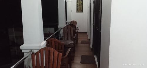 a row of wooden chairs in a hallway at Vino Villa Tourists & Local Accommodations - 24 Hrs in Kandy