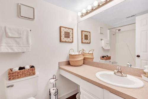 a white bathroom with a sink and a mirror at Modern Designed, Lakefront Home in Garland in Garland