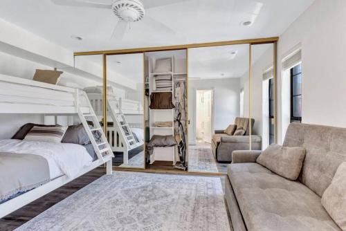 a bedroom with a bunk bed and a couch at Modern Designed, Lakefront Home in Garland in Garland