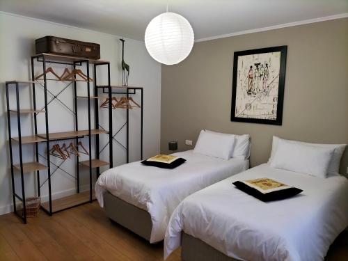 a bedroom with two beds and a book shelf at La Mouillère in Verton