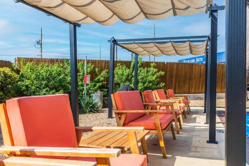 a row of chairs sitting under an umbrella at One Bed One Bath Affordable Apt With Balcony in Dallas