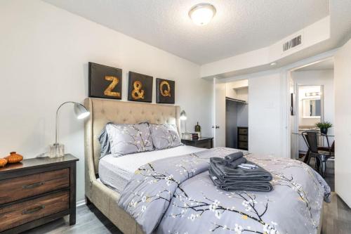 a bedroom with a king sized bed with a dresser at Cozy North Dallas One Bedroom Stay in Dallas
