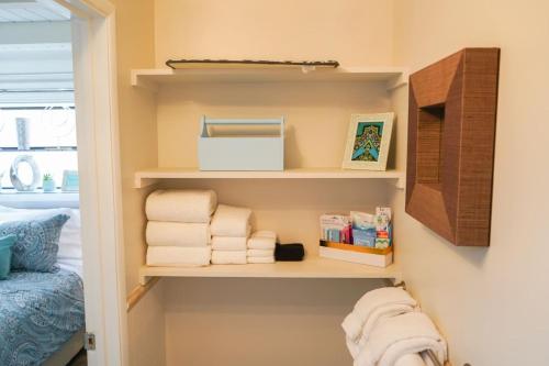 a closet with towels on shelves in a bedroom at STUNNINGLY PERFECT Beach ALL NEW REMODEL Galore in Laguna Beach