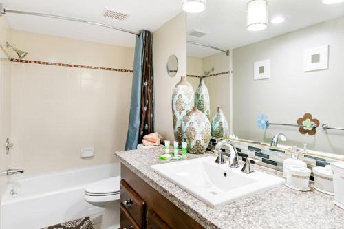a bathroom with a sink and a tub and a toilet at Unparalleled Villa Apartment in an Enchanting Village in Laguna Beach