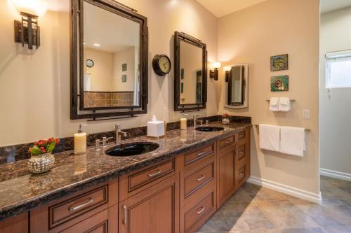 a bathroom with two sinks and a large mirror at Stunning huge one level 1350 ft. cottage in Mission Viejo