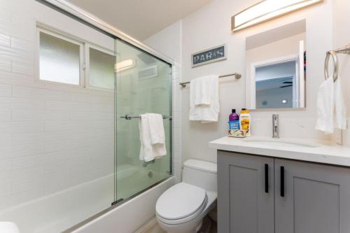 y baño con ducha, aseo y lavamanos. en 100 NEW STUNNING HUGE HOME, GARDEN BEACH, RESERVED PARKING, en Laguna Beach