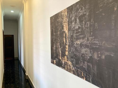 a painting on a wall in a hallway at Lotus Haven Villa in Siem Reap