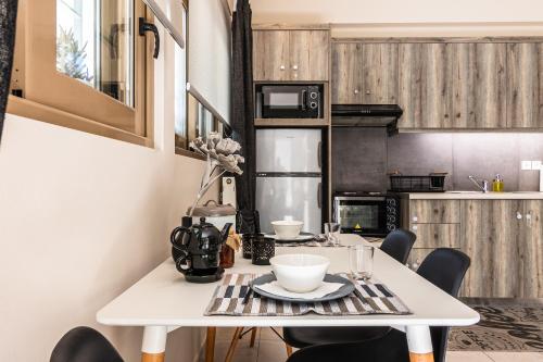 a kitchen with a white table and chairs at Dantis Place in Nafplio wheel chair accessible in Nafplio