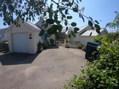 a driveway leading to a house with a garage at Number Six in Truro