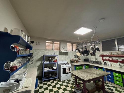 a kitchen with a stove and a table in it at Posada 1914 in Panama City